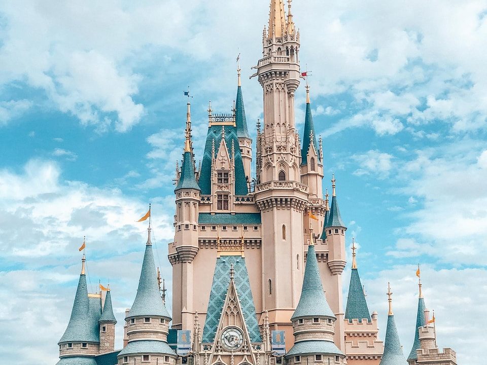 white and blue castle under blue sky and white clouds during daytime