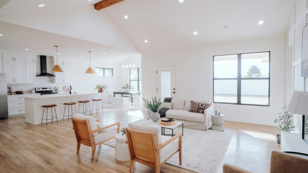 a living room filled with furniture and a kitchen
